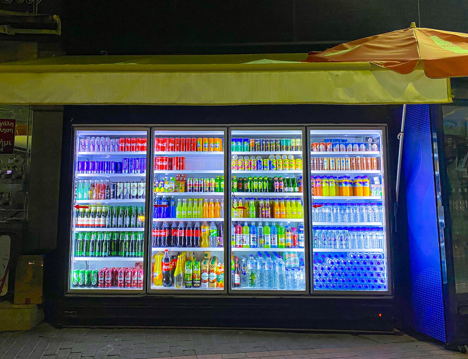 a store with a cooler full of drinks